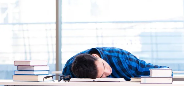 Student studying in the empty library with book preparing for ex — Stock Photo, Image