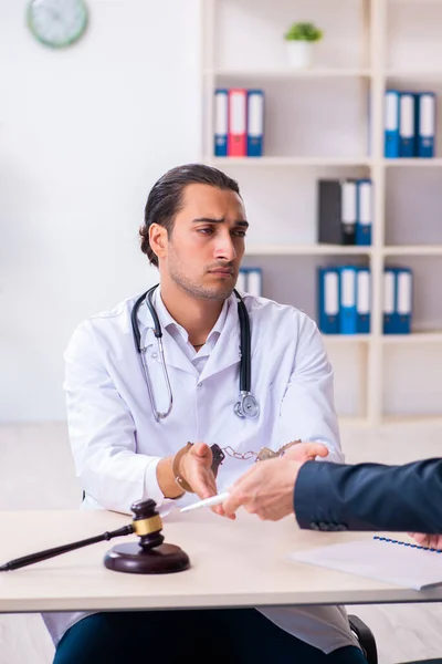 Male doctor in courthouse meeting with lawyer