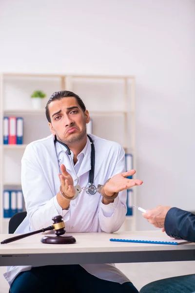 Male doctor in courthouse meeting with lawyer