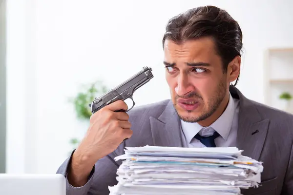 Young male employee unhappy with excessive work — Stock Photo, Image