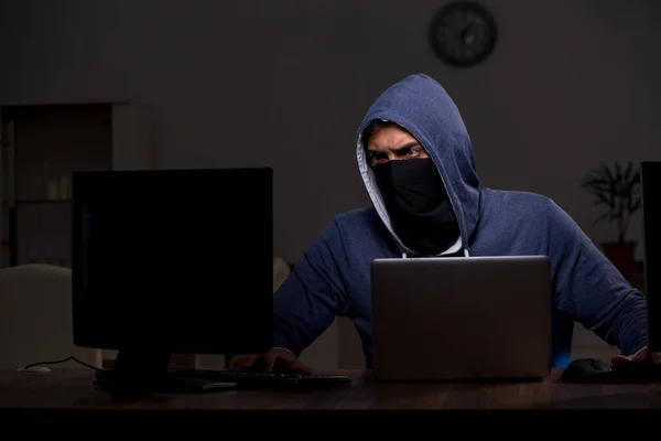 Male hacker hacking security firewall late in office — Stock Photo, Image