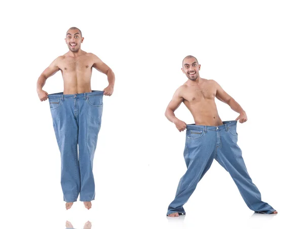 Homem em dieta conceito com jeans de grandes dimensões — Fotografia de Stock