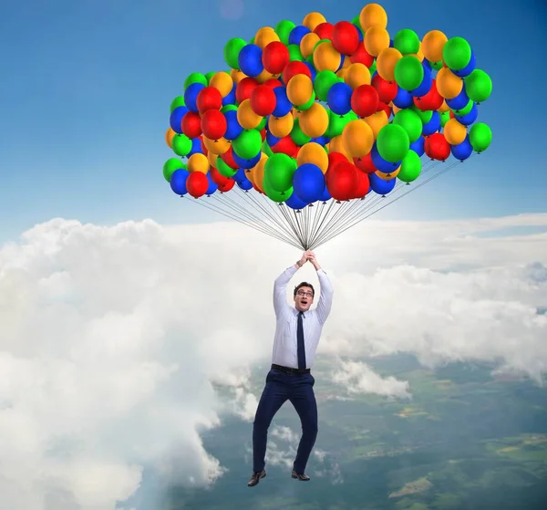 Businessman flying on balloons in challenge concept