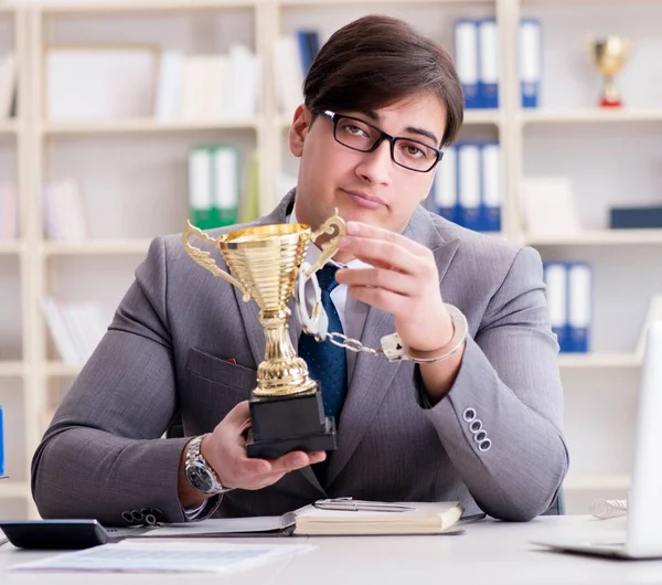 Businessman with golden cup in the office — Stock Photo, Image