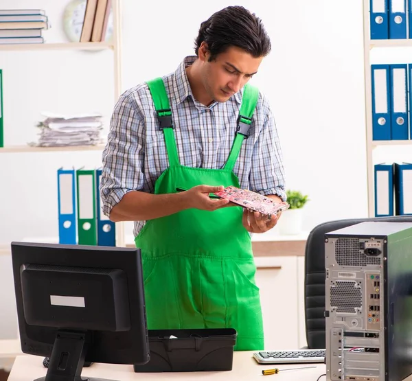 Jonge ingenieur repareert kapotte computer op kantoor — Stockfoto