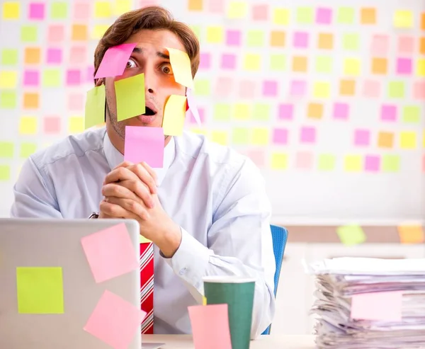 Young handsome man in conflicting priorities concept — Stock Photo, Image