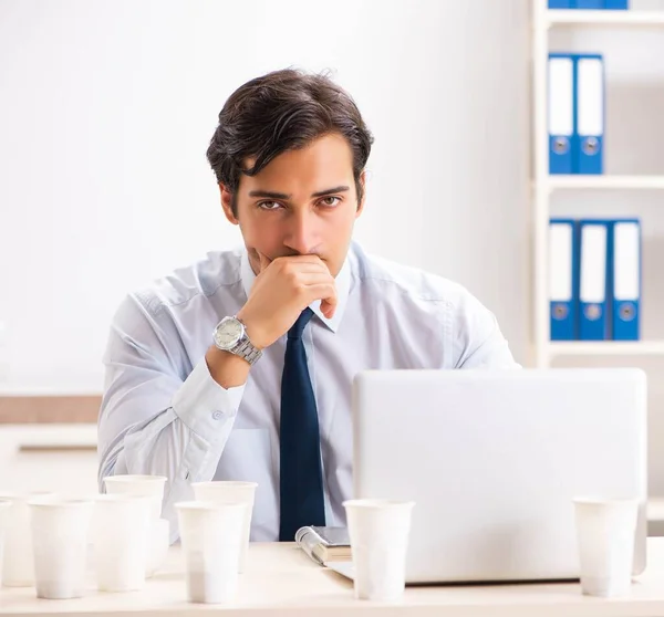 Young employee addicted to coffee — Stock Photo, Image