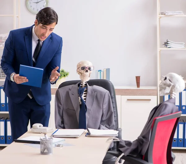 Funny business meeting with boss and skeletons