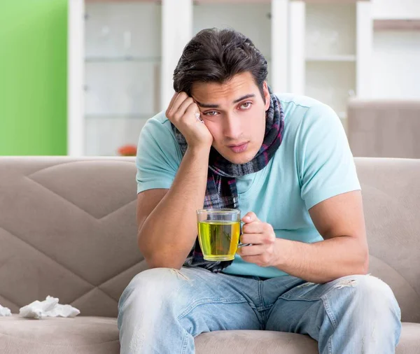 Young handsome man suffering from illness at home — Stock Photo, Image