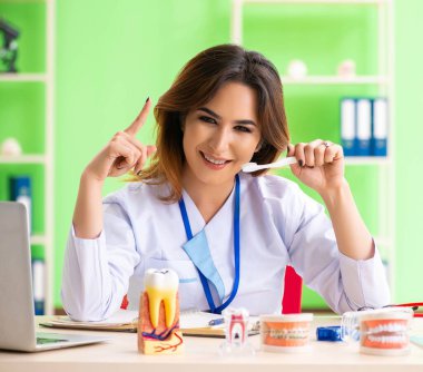 Diş implantı üzerinde çalışan kadın dişçi.