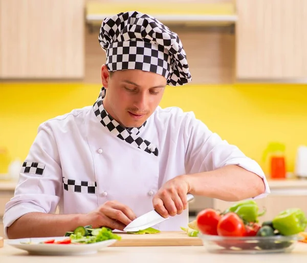 Young professional cook preparing salad at kitchen — Stock Photo, Image