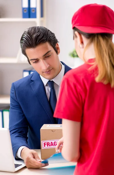 Courier delivering parcel to the office — Stock Photo, Image