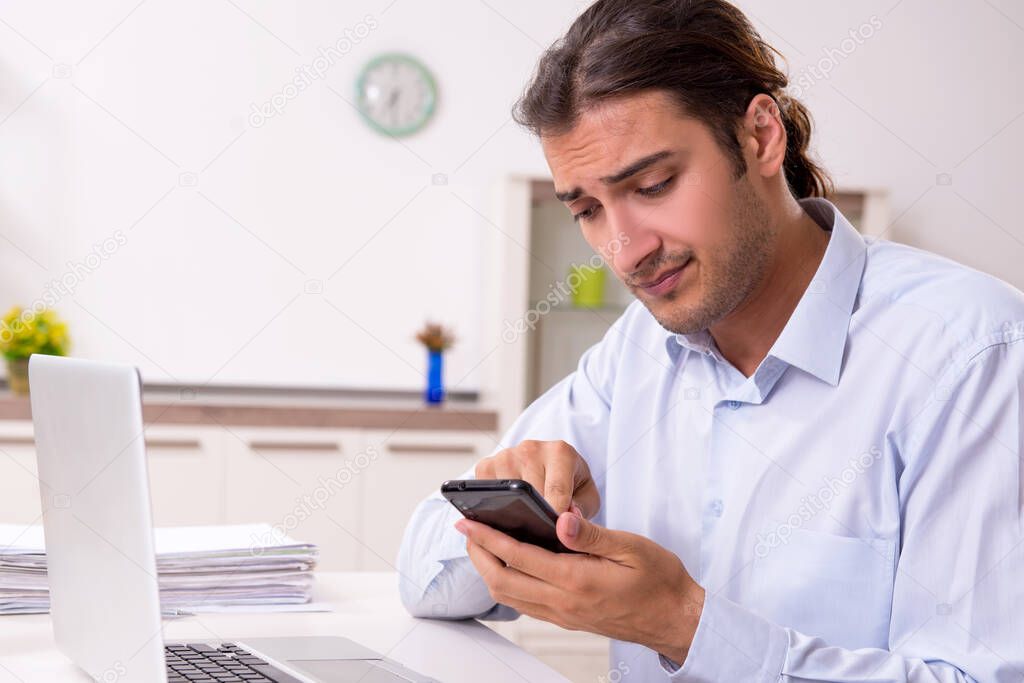 Young male businessman working at home