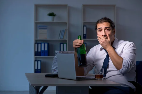 Alcohol addicted businessman working late in the office — Stock Photo, Image