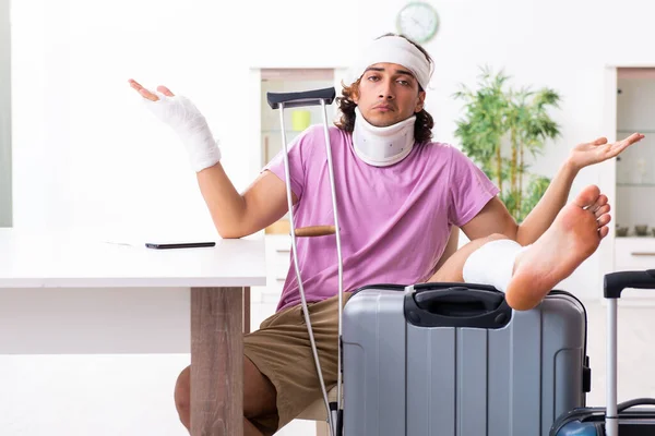 Young injured man preparing for the trip