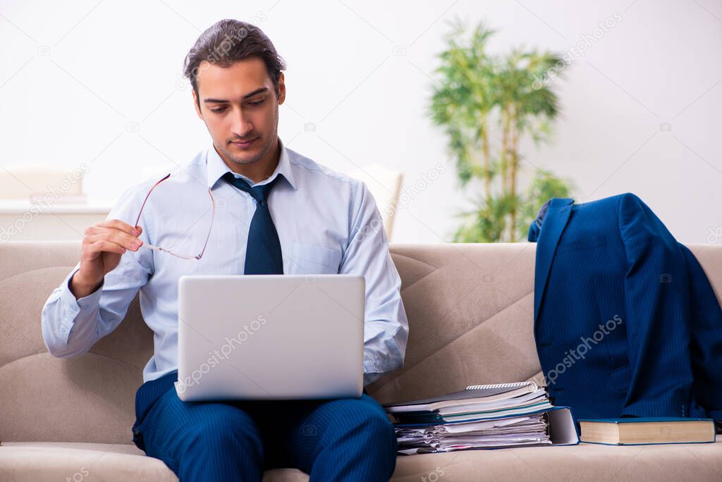 Young male employee working from house