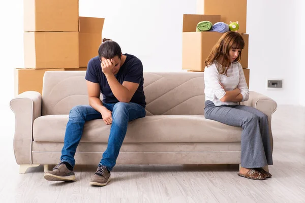 Young pair and many boxes in divorce settlement concept