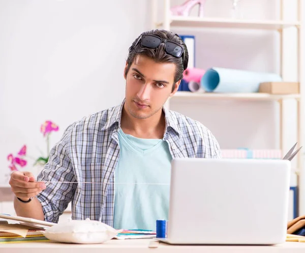 Young handsome tailor working in his workshop — Stock Photo, Image