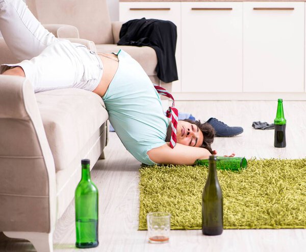 Young drunk handsome man after party at home