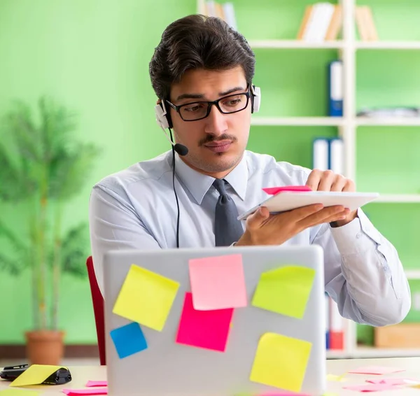 Young help desk operator working in office with many conflicting — Stock Photo, Image