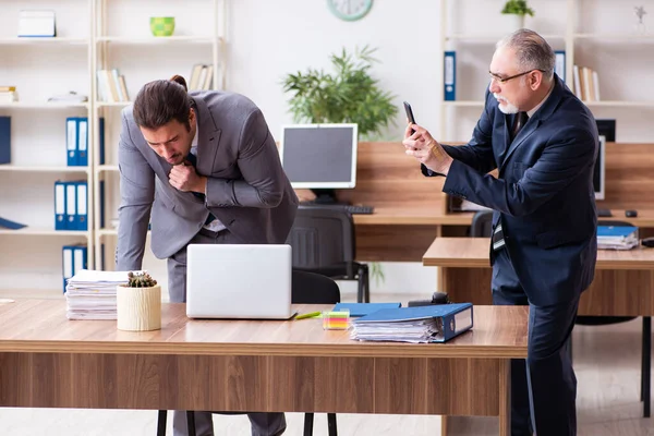 Two employees in pandemic concept at workplace