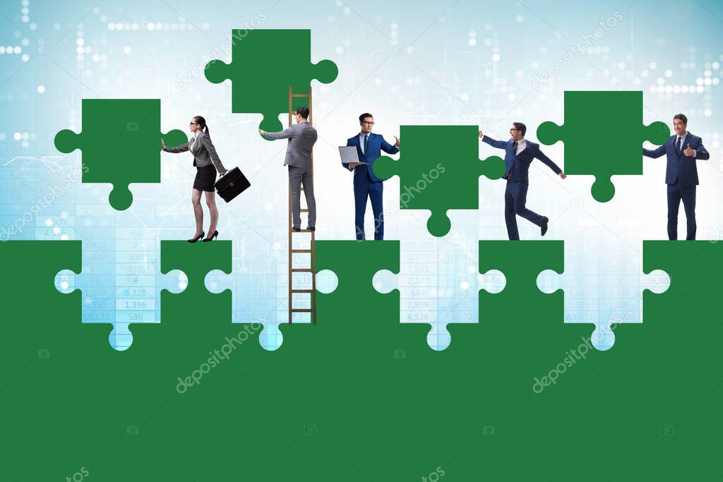 Businessman in teamwork concept with jigsaw puzzle