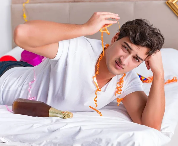 Man after heavy christmas partying at home — Stock Photo, Image