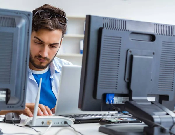 IT technician looking at IT equipment