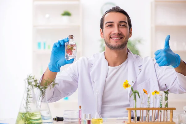 Young male chemist in perfume synthesis concept — Stock Photo, Image