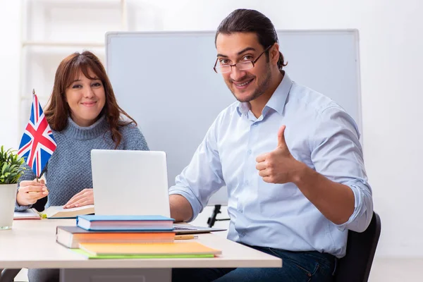 Jonge vrouwelijke student en mannelijke leraar Engels in de klas — Stockfoto