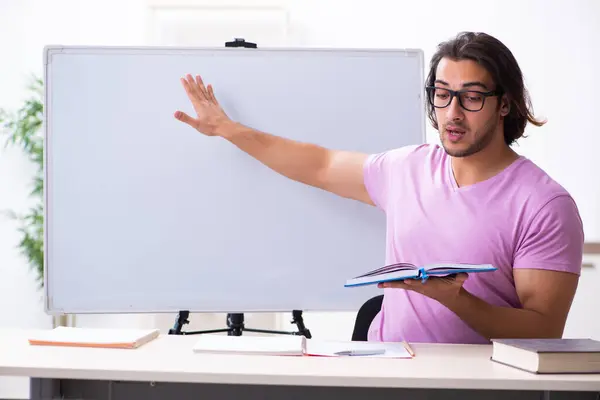 Young male student in the classroom — Stock Photo, Image