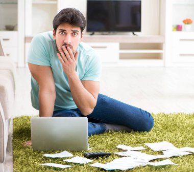 Genç adam kişisel finans ve faturalarla boğuşuyor.