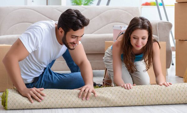 The young family unpacking at new house with boxes