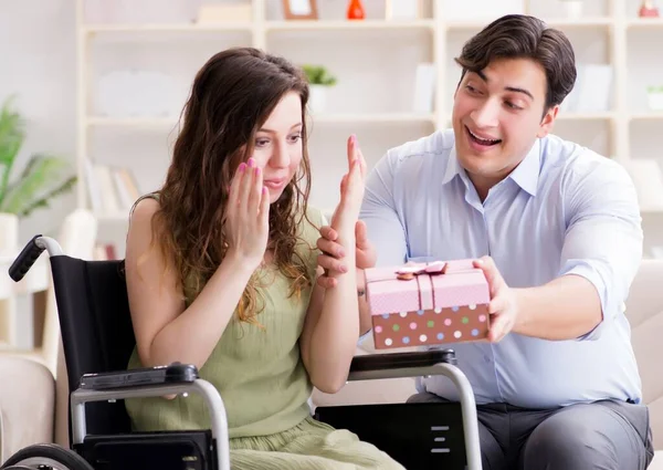 The man making marriage proposal to disabled woman on wheelchair