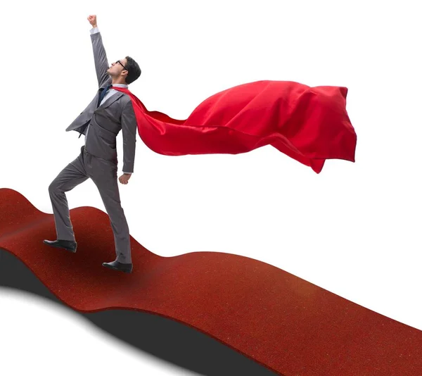 El superhéroe en la alfombra roja en concepto de éxito — Foto de Stock