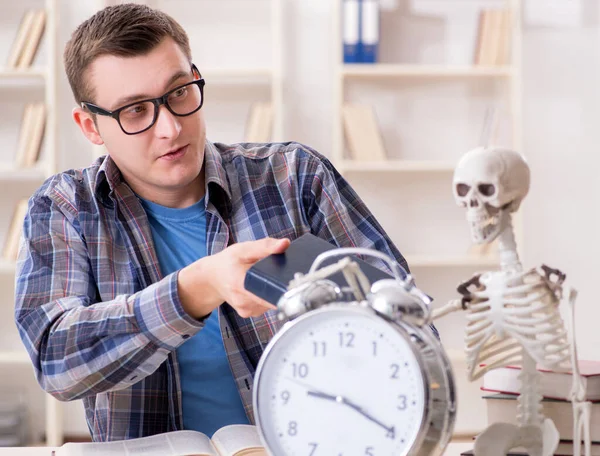 Student and skeleton preparing for school exams — Stock Photo, Image