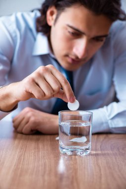 Hasta erkek çalışan ofiste acı çekiyor.