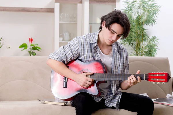 Joven con guitarra en casa — Foto de Stock