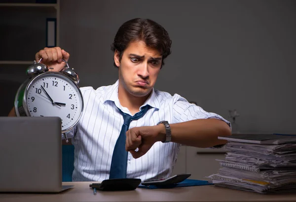 Young financial manager working late at night in office