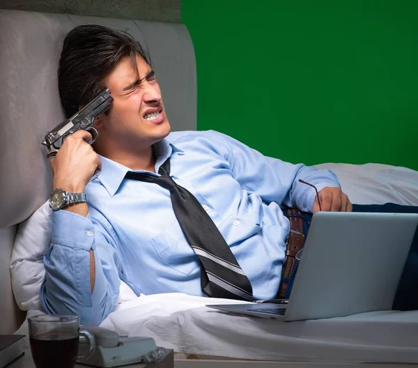 Young businessman under stress in the bedroom at night Royalty Free Stock Images