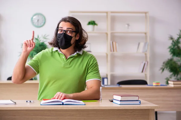 Young man student studying at home in self-isolation concept