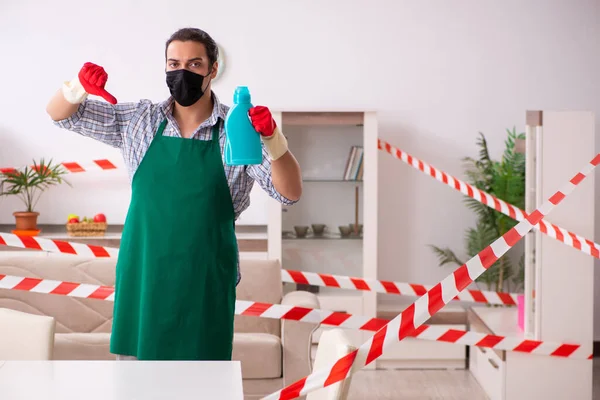 Young male sanitizer disinfecting indoors — Stock Photo, Image
