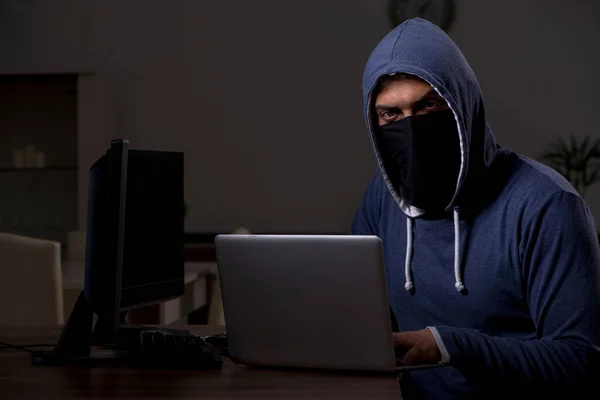 Male hacker hacking security firewall late in office — Stock Photo, Image