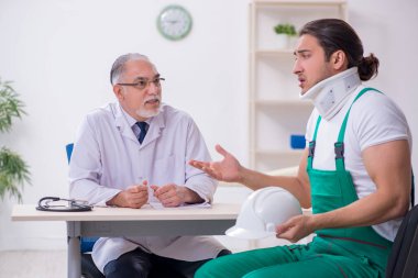 Genç erkek müteahhit yaşlı doktoru ziyaret ediyor.