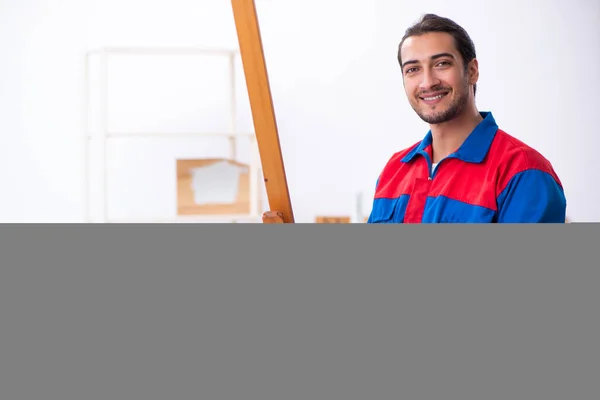 Young male contractor working in workshop — Stock Photo, Image