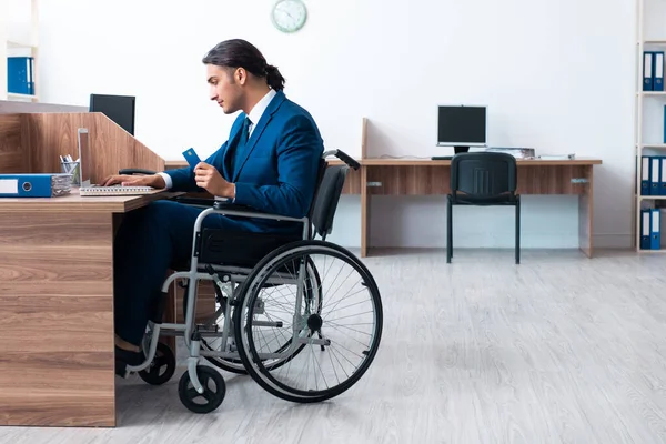 Young male employee in wheel-chair — Stock Photo, Image