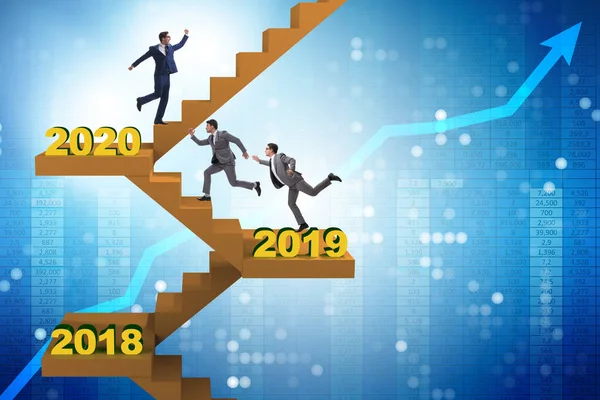 Businessman climbing stairs on yearly basis — Stock Photo, Image