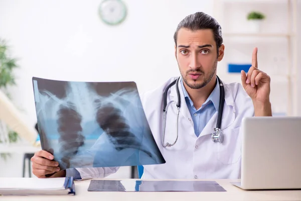 Young handsome male doctor working in the clinic — Stock Photo, Image