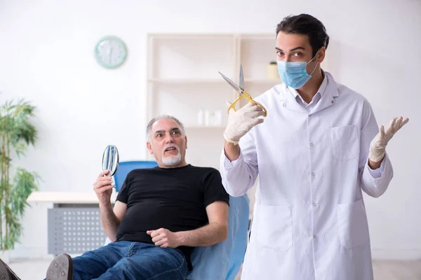 Old man visiting young doctor for plastic surgery — Stock Photo, Image