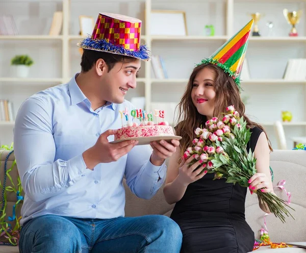 Молода пара святкує день народження з тортом — стокове фото
